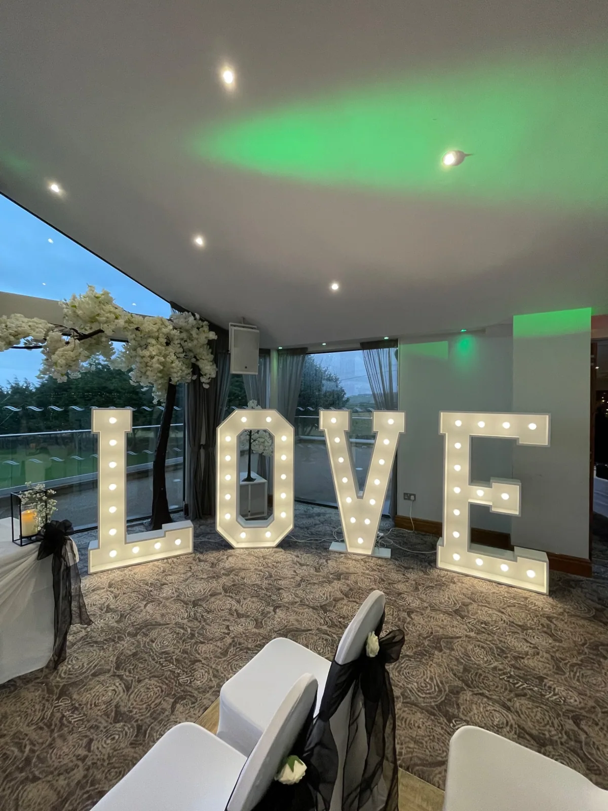 Illuminated LOVE letters at wedding