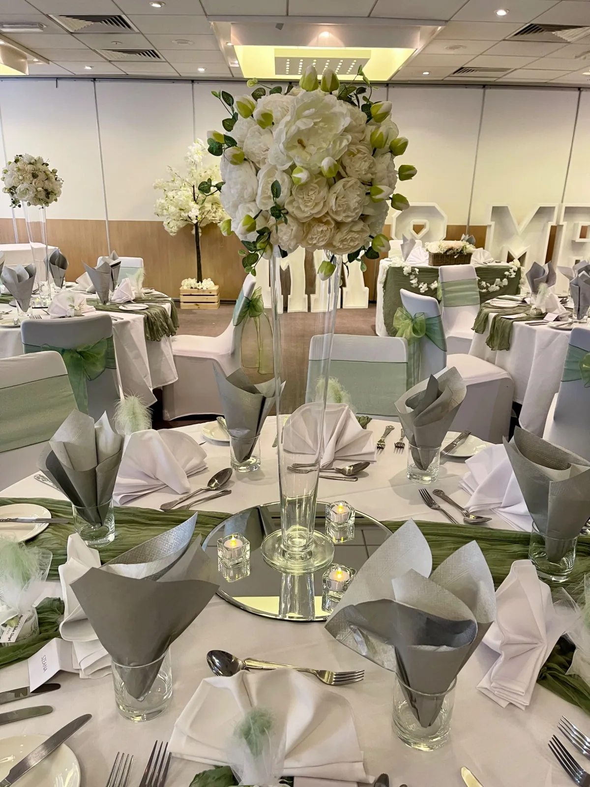 White floral centrepiece at sage wedding